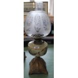 A metal base oil lamp with painted opal glass bowl and etched globe