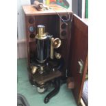 A cased Watson Service brass microscope