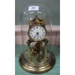 A brass and glass dome top clock