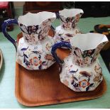 A set of three 19th Century pottery jugs with blue and iron red floral decoration