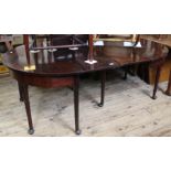 A late 18th Century two part mahogany dining table with drop leaf extension to centre