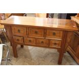 A modern Chinese hardwood seven drawer sideboard