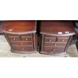 A pair of modern bedside cabinets on castors