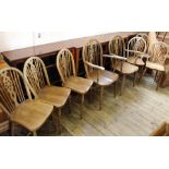 A set of eight beech and elm wheel back dining chairs with two carvers