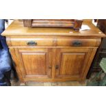 An Edwardian carved oak two door two drawer sideboard