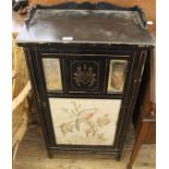 An Edwardian pine ebonised and gilt one door cupboard with tapestry behind glass