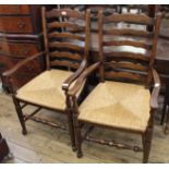 A pair of oak rushed seat ladder back carvers