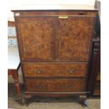 A reproduction burr walnut veneer two drawer two door cabinet