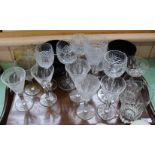 A mahogany tea tray containing slice cut stem plus other wine glasses and two large amber glass