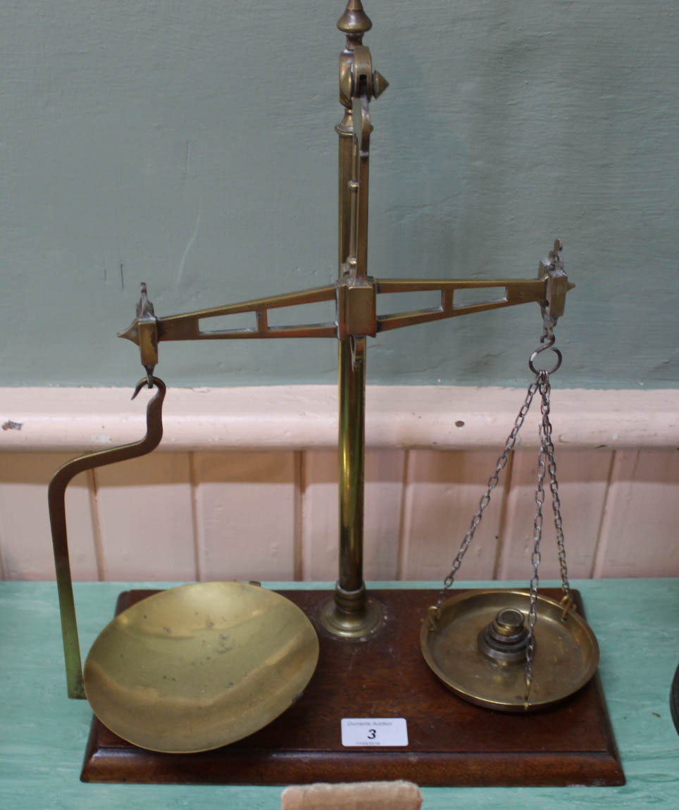 A brass and mahogany balance scale and weights