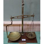 A brass and mahogany balance scale and weights