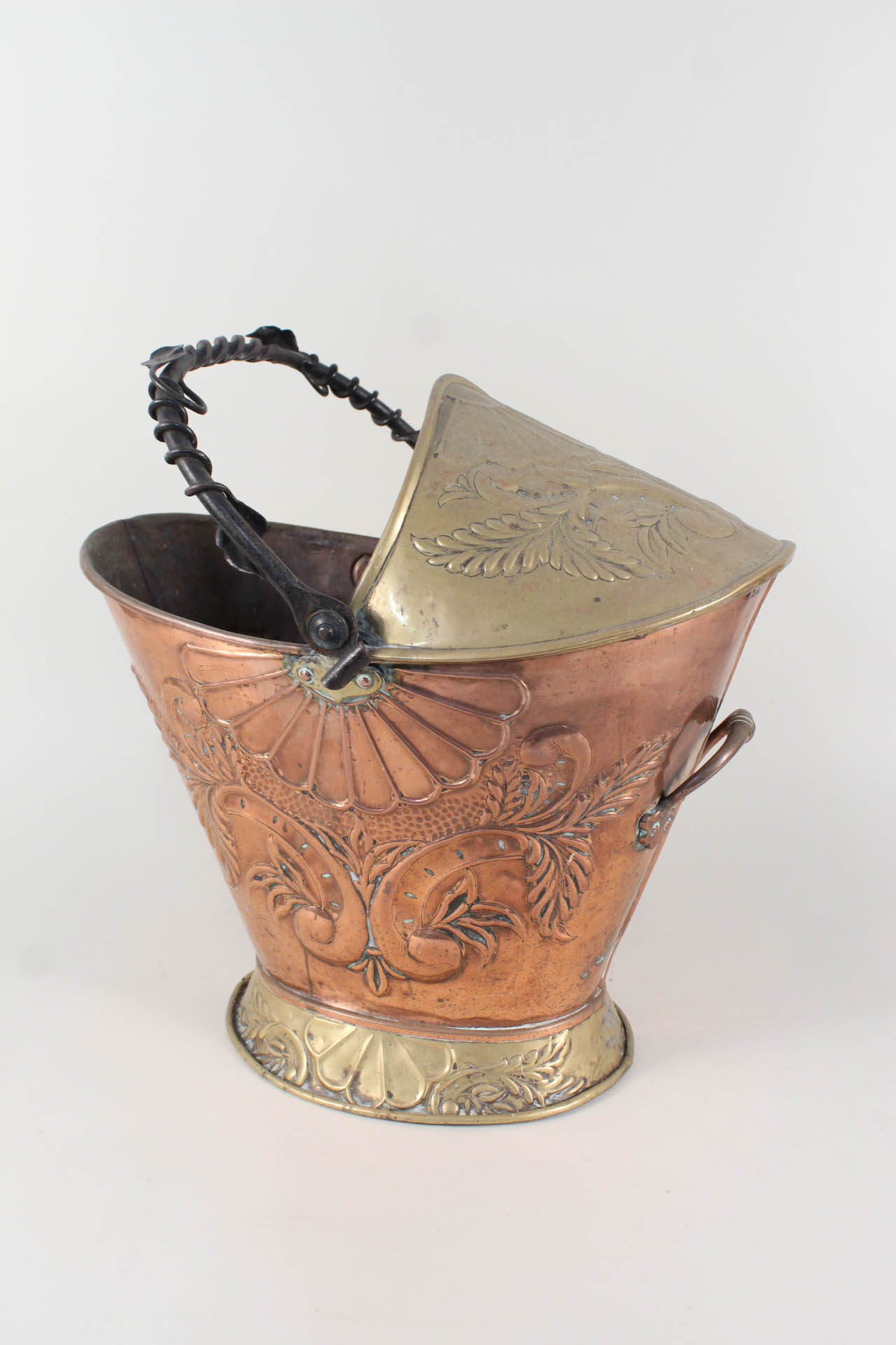 An embossed copper and brass coal helmet with wrought iron handle and inscription 'First Class