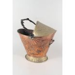 An embossed copper and brass coal helmet with wrought iron handle and inscription 'First Class