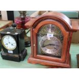 A modern mahogany striking mantel clock plus an ebonised clock