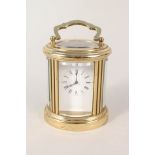 A small oval brass carriage clock