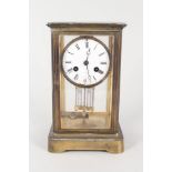 A brass four sided glass mantel clock with mercury pendulum (chipped dial)