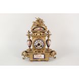 A 19th Century French gilt metal striking mantel clock with bird and leaf crest,