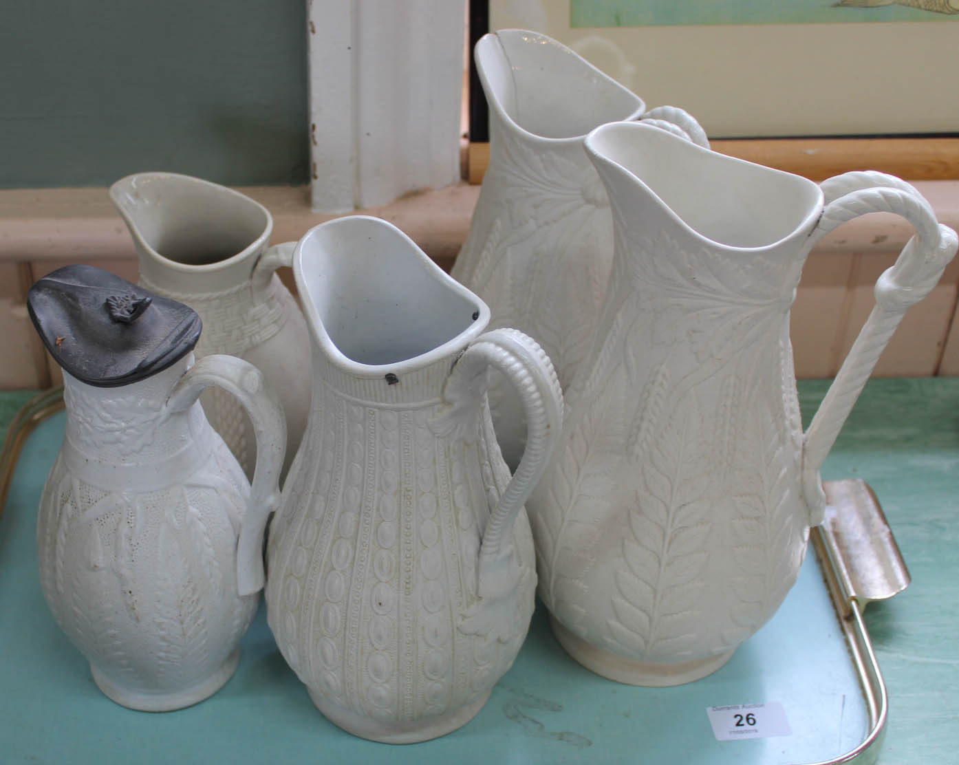 Five Victorian stoneware relief moulded jugs including Copeland and Dudson