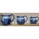 A set of three modern blue and white stoneware jugs