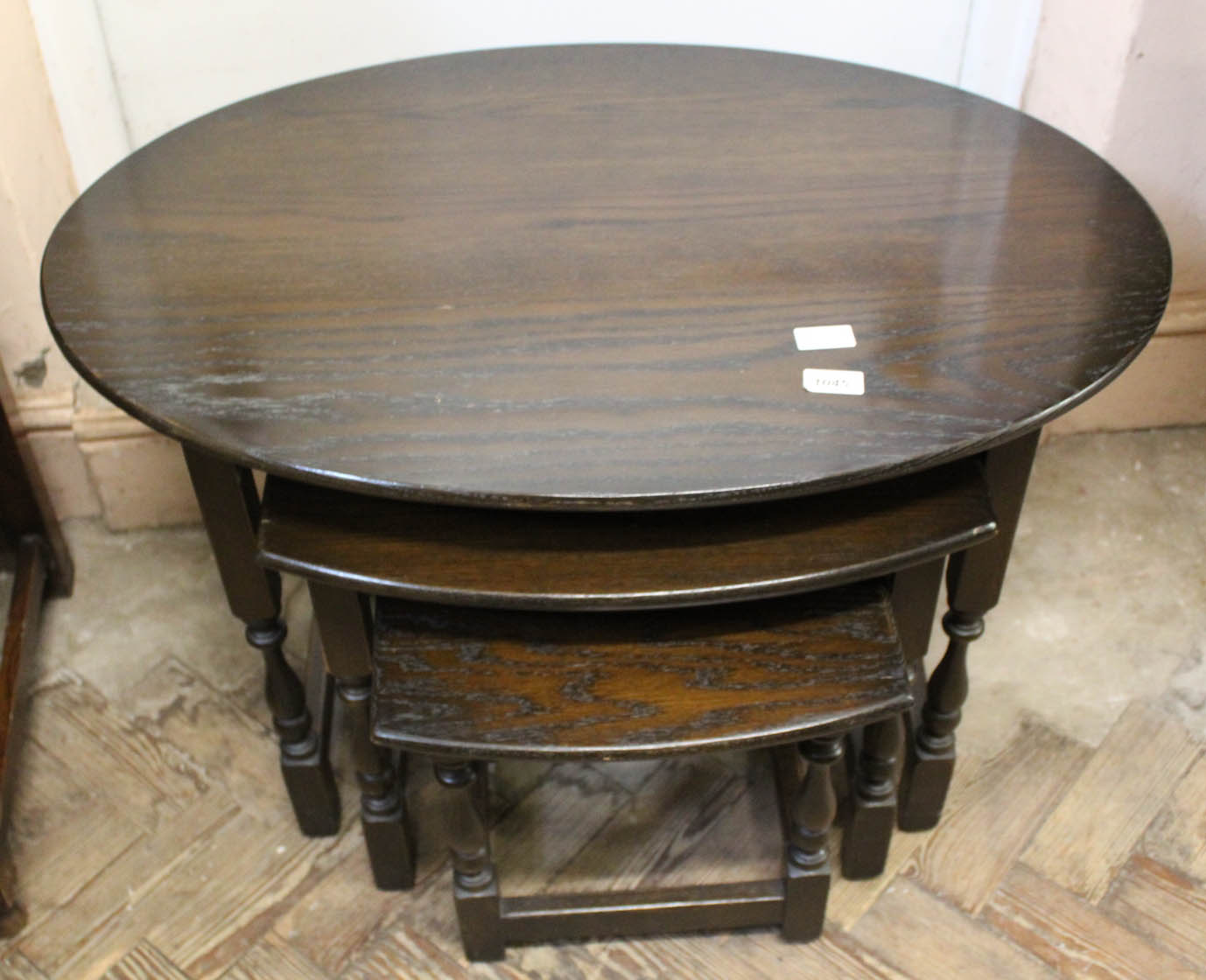 A nest of three oak oval tables