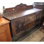 An Edwardian carved oak buffet stand