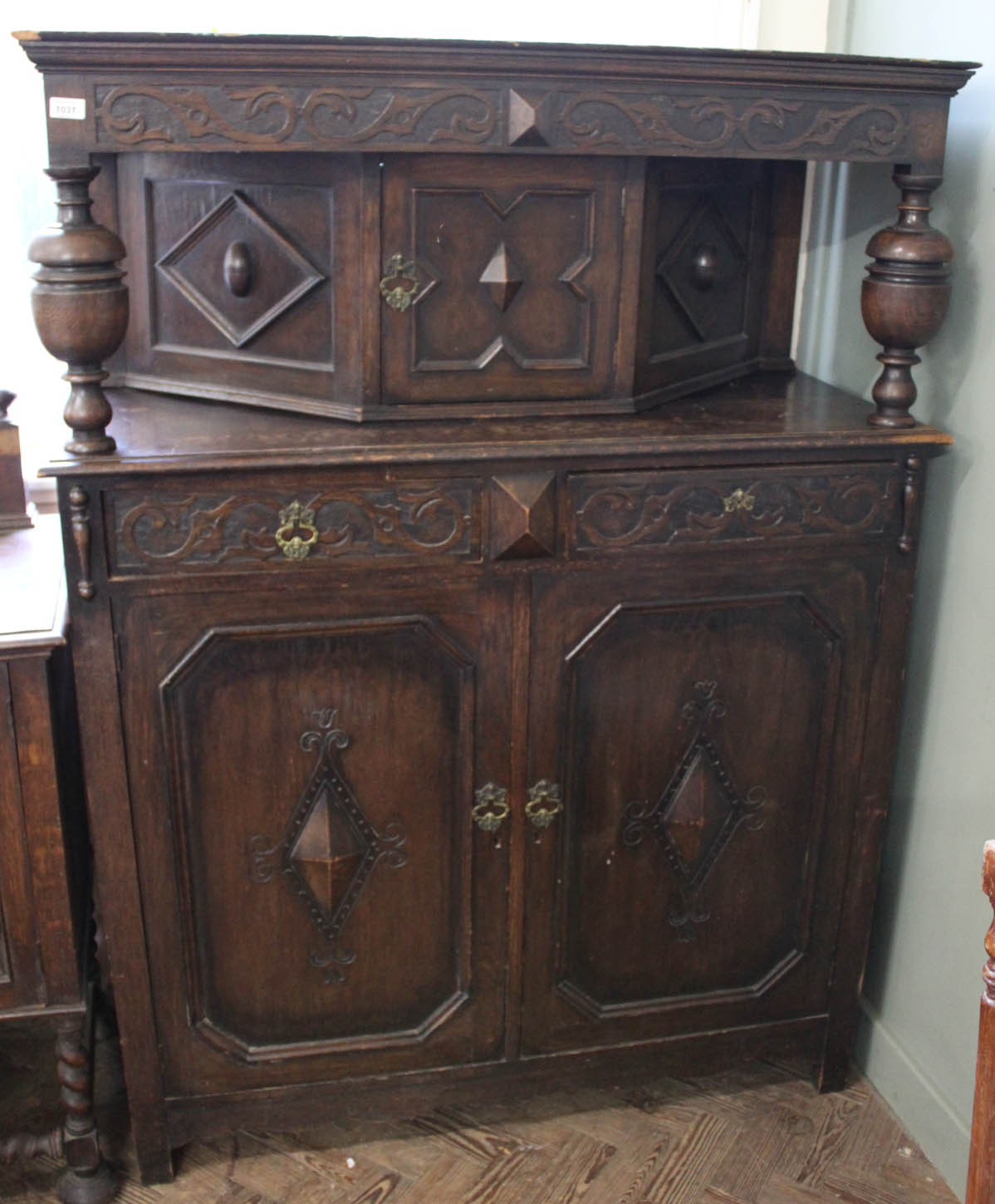 An Edwardian carved oak court cupboard