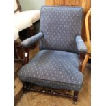 A blue upholstered low armchair