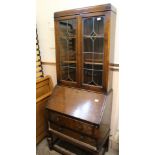 A 1920's oak bureau bookcase with lead lined glass