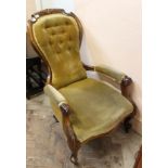 A Victorian carved mahogany gold upholstered armchair with button back