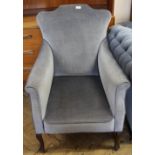 A pair of blue velvet armchairs