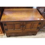 A modern carved oak two drawer two door cupboard