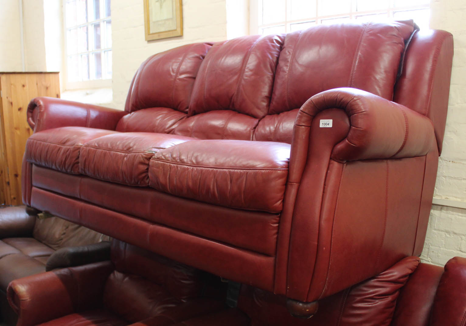 A three seater red leather sofa