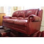 A three seater red leather sofa