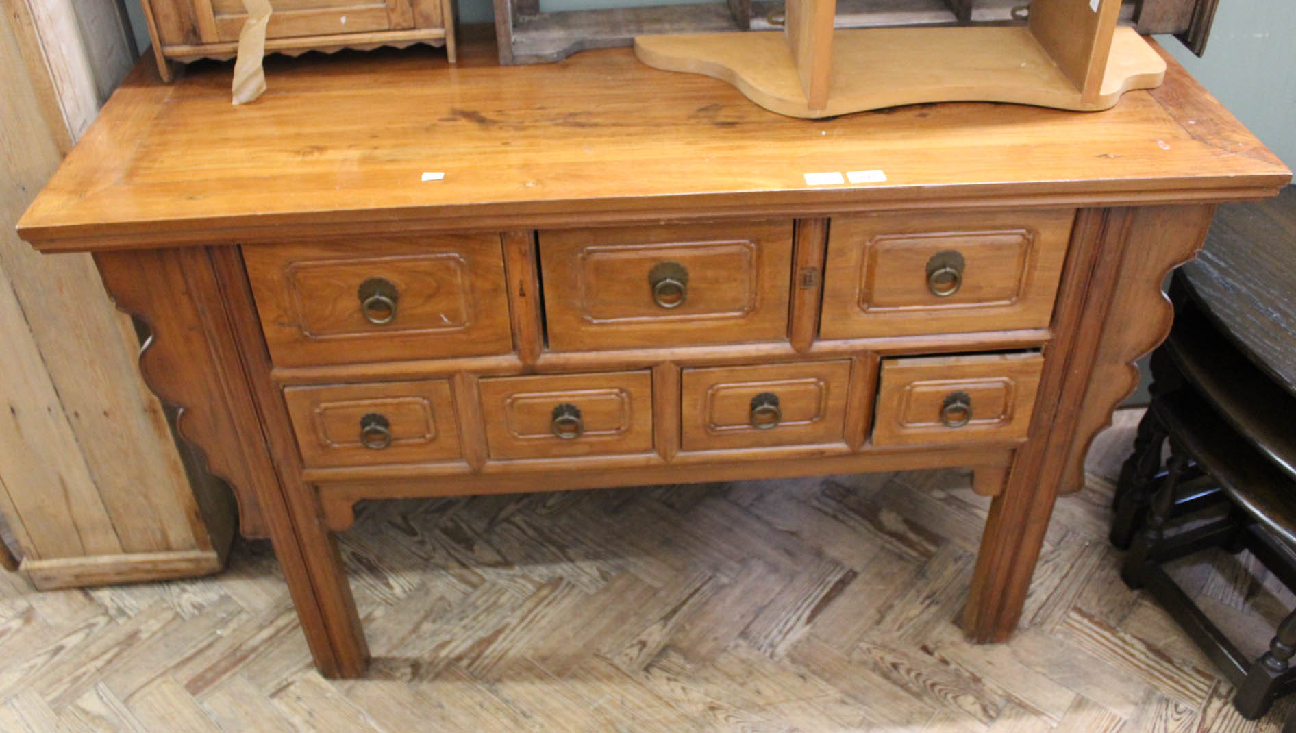 A modern Chinese hardwood seven drawer sideboard and a vintage bamboo side occasional table with