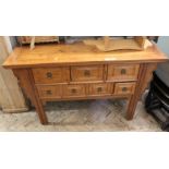 A modern Chinese hardwood seven drawer sideboard and a vintage bamboo side occasional table with
