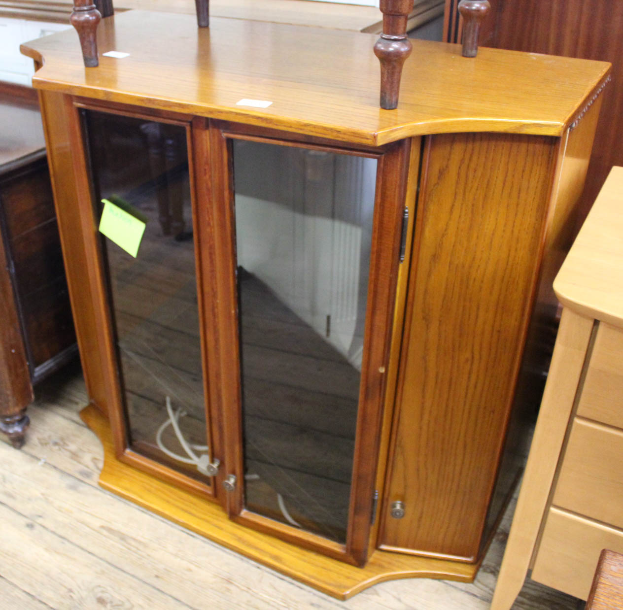 A glass fronted oak effect hi-fi unit