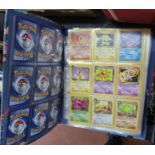 An album of Pokemon cards including Dark-Charizard etc