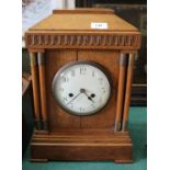 An oak cased striking mantel clock