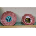 A pair of pink ground dishes with male and female relief decoration