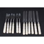 A set of six silver bladed mother of pearl handled knives and forks,