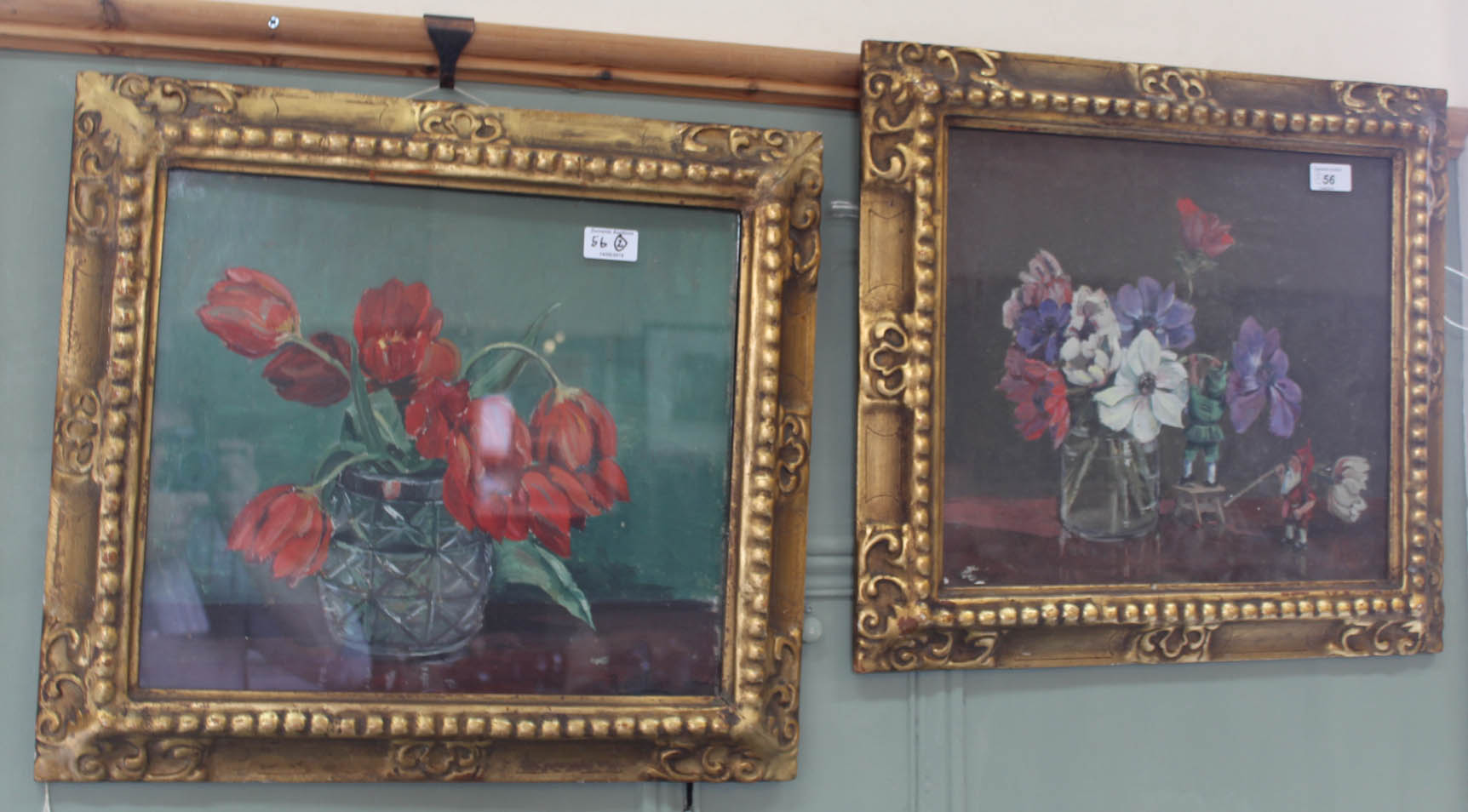 A pair of Rowland Fisher still life floral paintings, one with small gnomes,