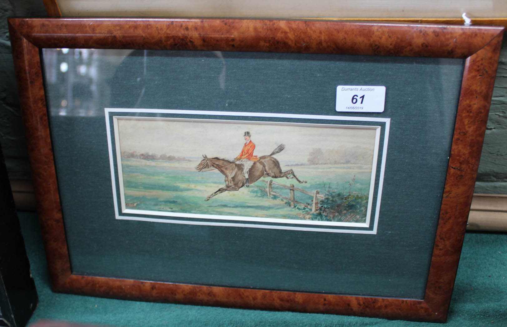 Brush watercolour of a horse and rider over jump,