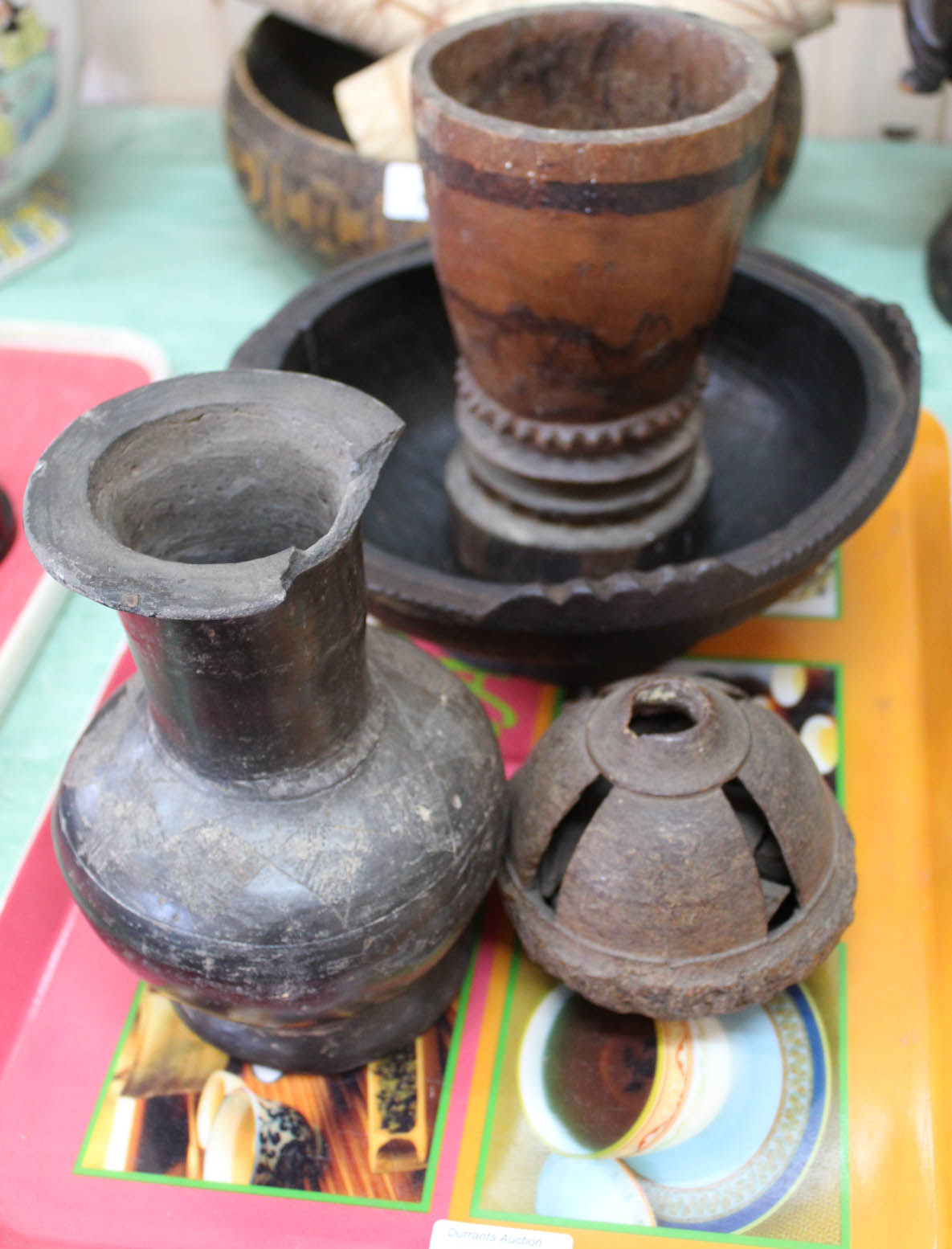 Four various African wood vessels plus a carved seed pot