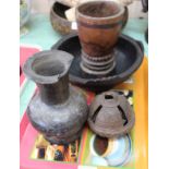 Four various African wood vessels plus a carved seed pot