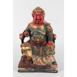 A Chinese polychrome wood carving of an emperor,