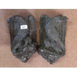 A pair of 19th Century carved oak eagle wall plaques,