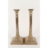 A large pair of 18th Century seamed brass candlesticks with fluted cylindrical stems,