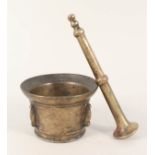 A 17th Century Spanish bronze mortar with four protruding buttresses 4" diameter and a brass pestle,