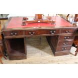 A reproduction mahogany pedestal desk with red leather top