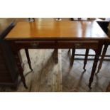 An Edwardian mahogany two drawer table